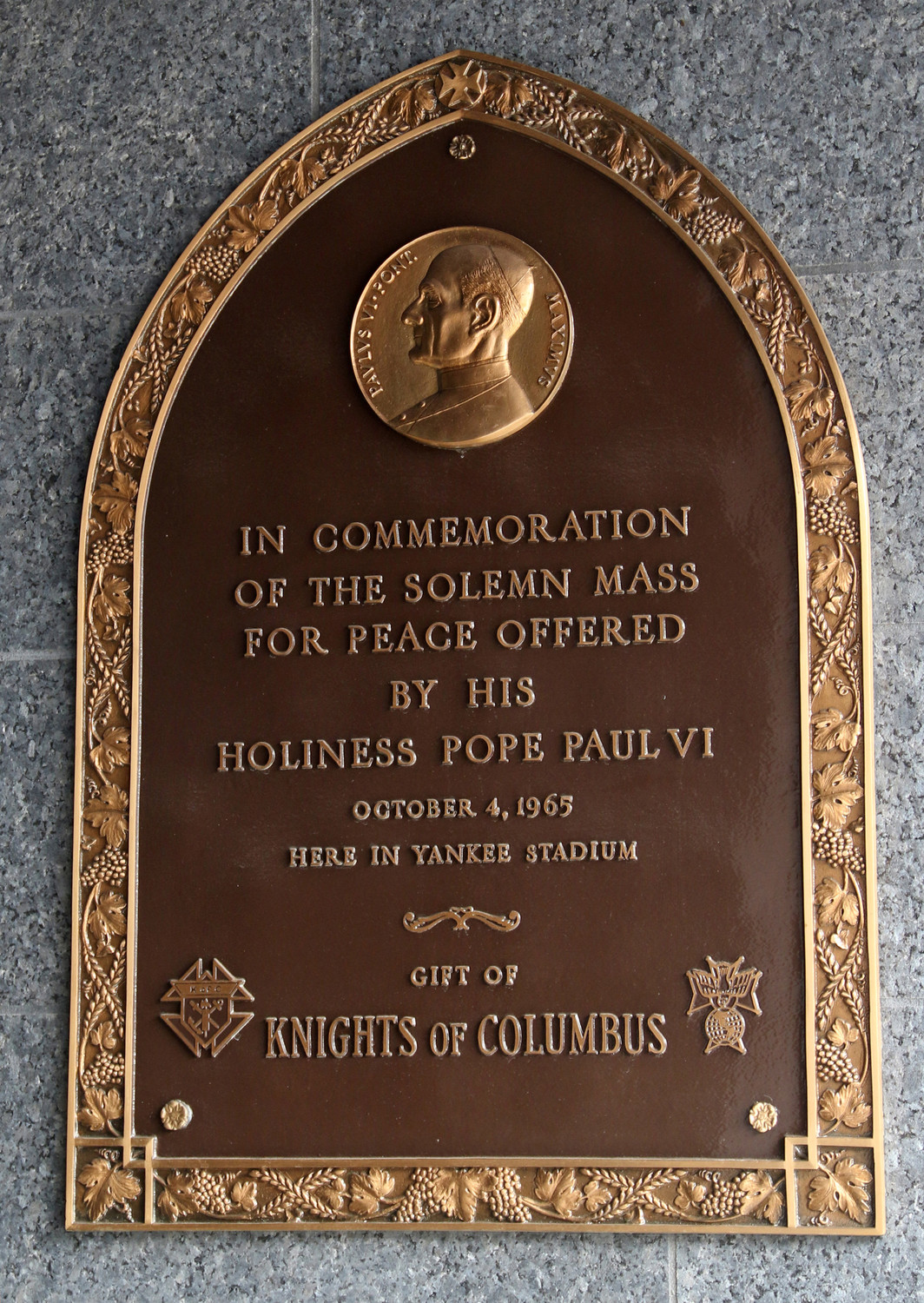 A bronze plaque commemorating the Mass celebrated by Pope Paul VI Oct. 4, 1965, in New York is seen July 30 in Monument Park at Yankee Stadium in the Bronx, N.Y. Blessed Paul, who will be canonized on Oct. 14, offered a “Mass for Peace” at the original Yankee Stadium during his one-day visit to New York, which marked the first trip by a Pope to the Western Hemisphere.